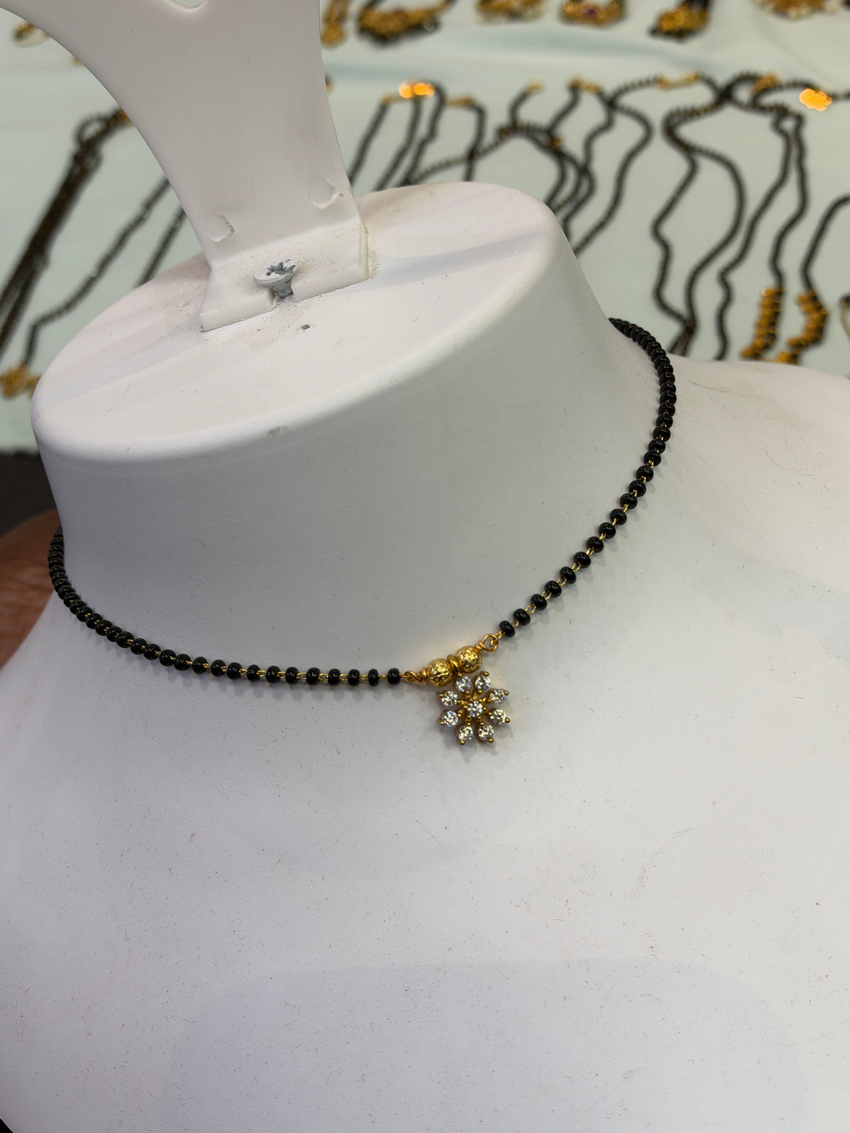 9 stones flower 
Black beads 18 inches BB411