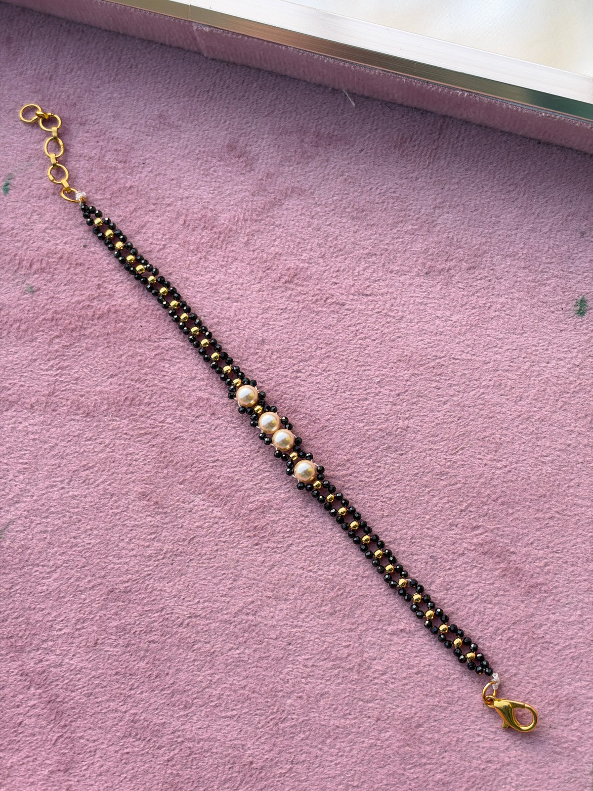 Br0014 Crystal black bead and gold balls with pearls