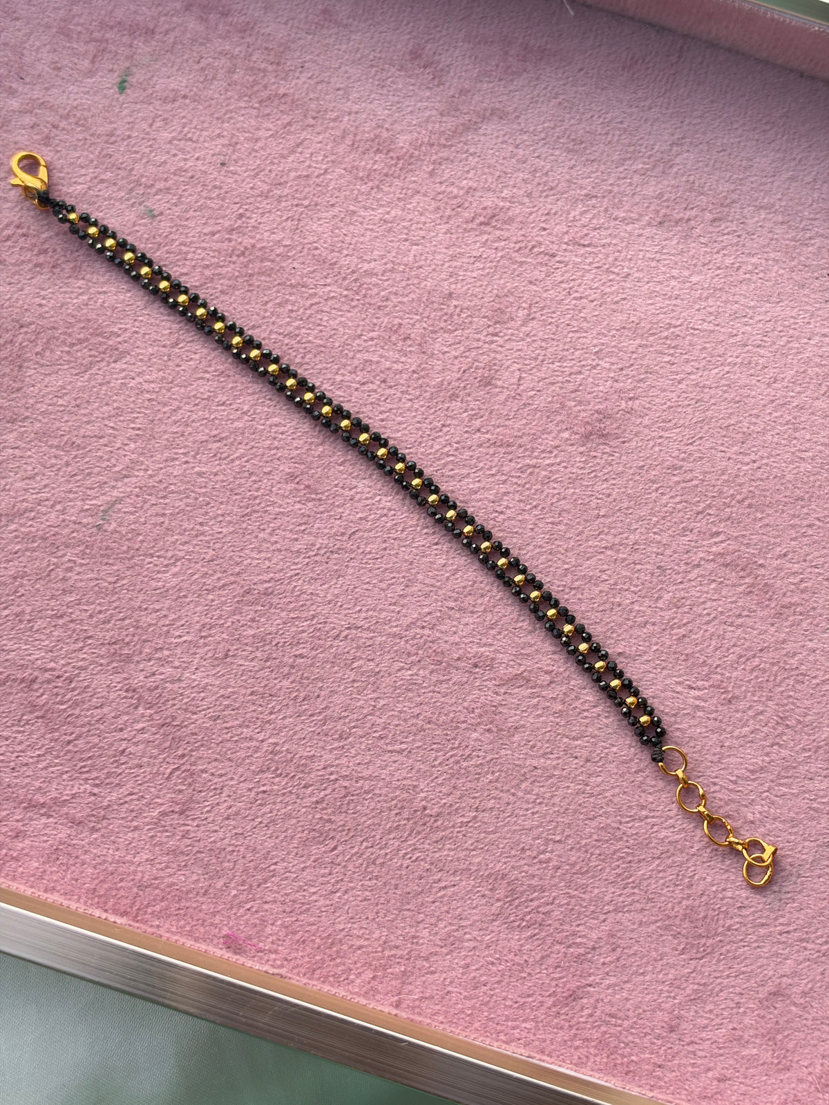 Br009 crystal black bead and gold balls bracelet 6 inches