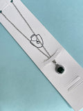 Silver chain with green circle pendant
