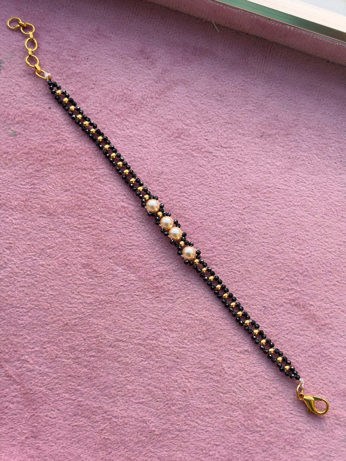 Br0014 Crystal black bead and gold balls with pearls