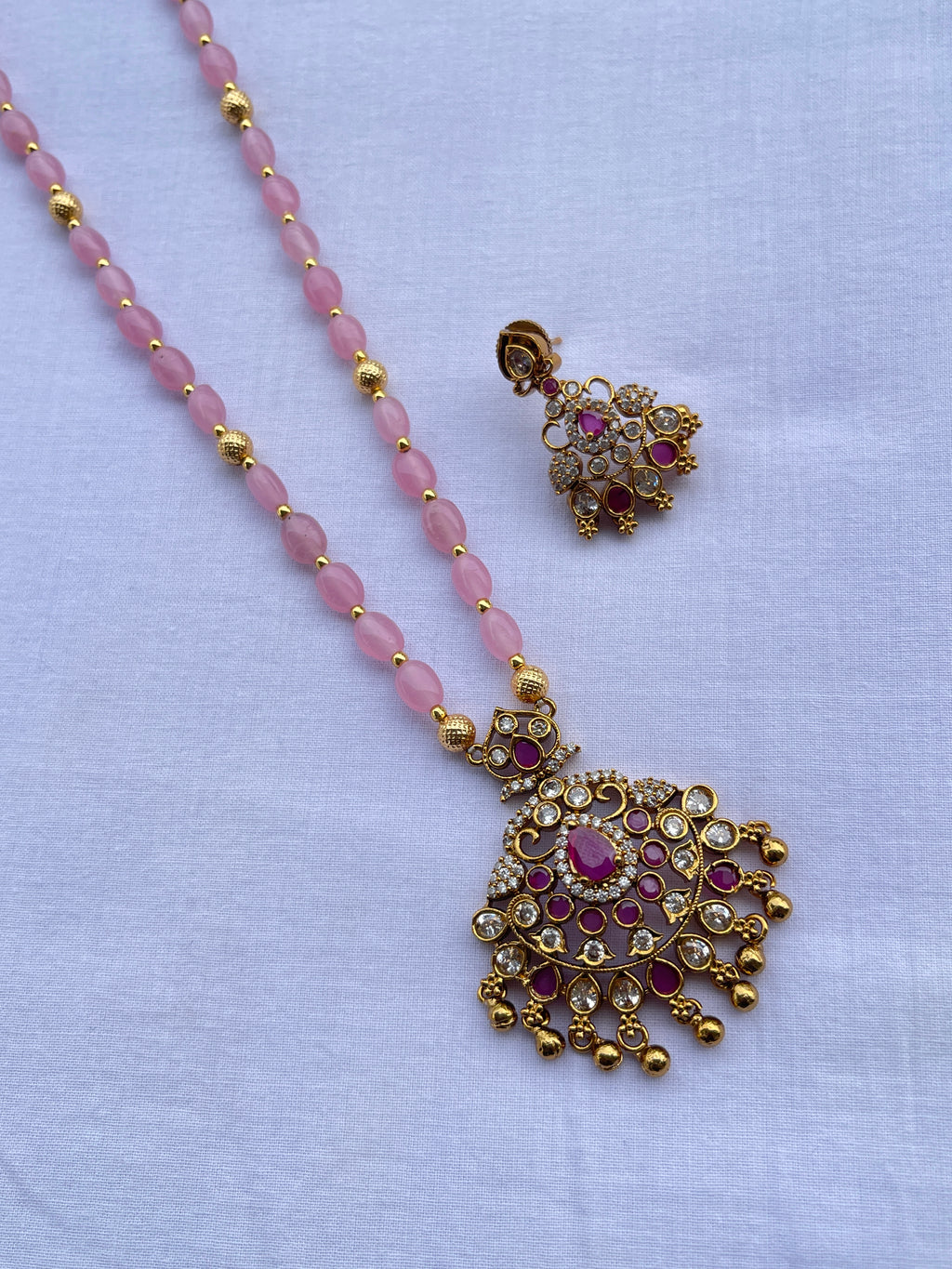 Light pink beads with pendant and earrings