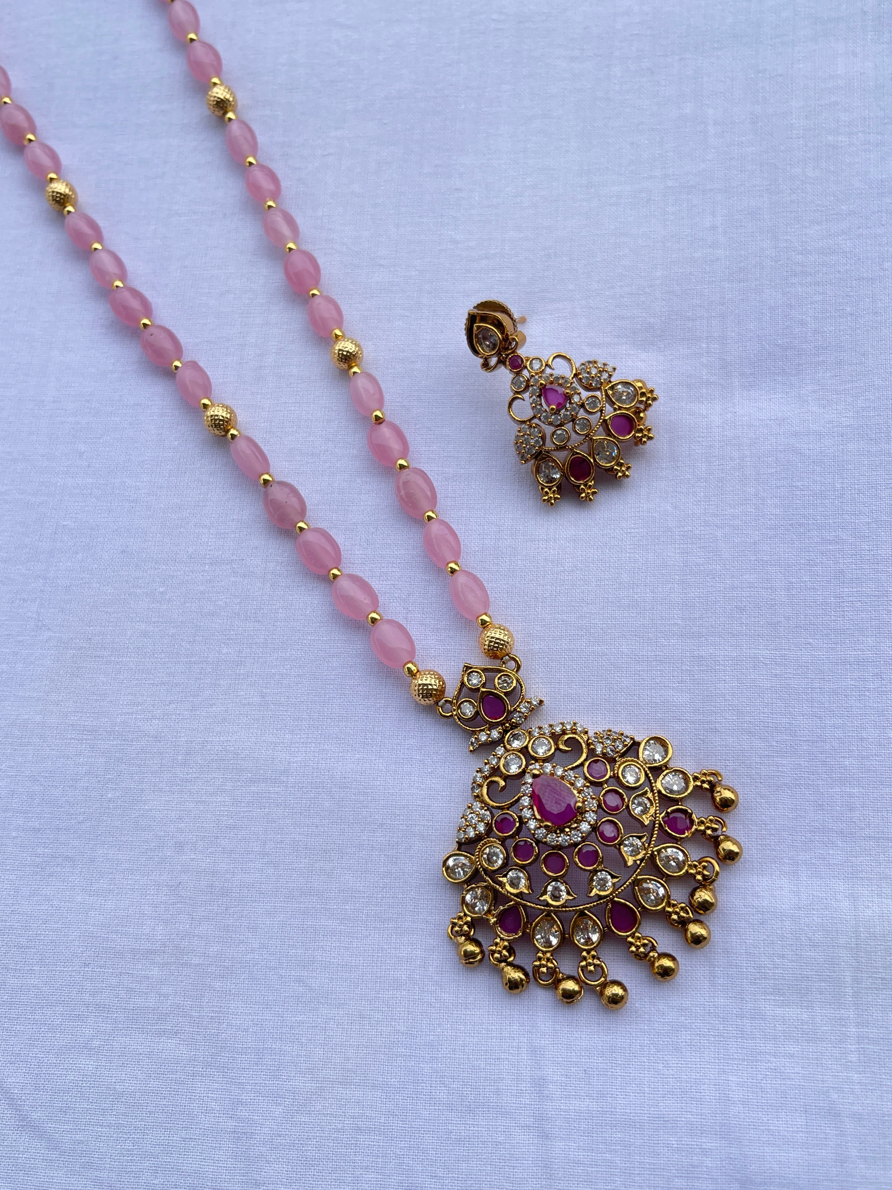 Light pink beads with pendant and earrings
