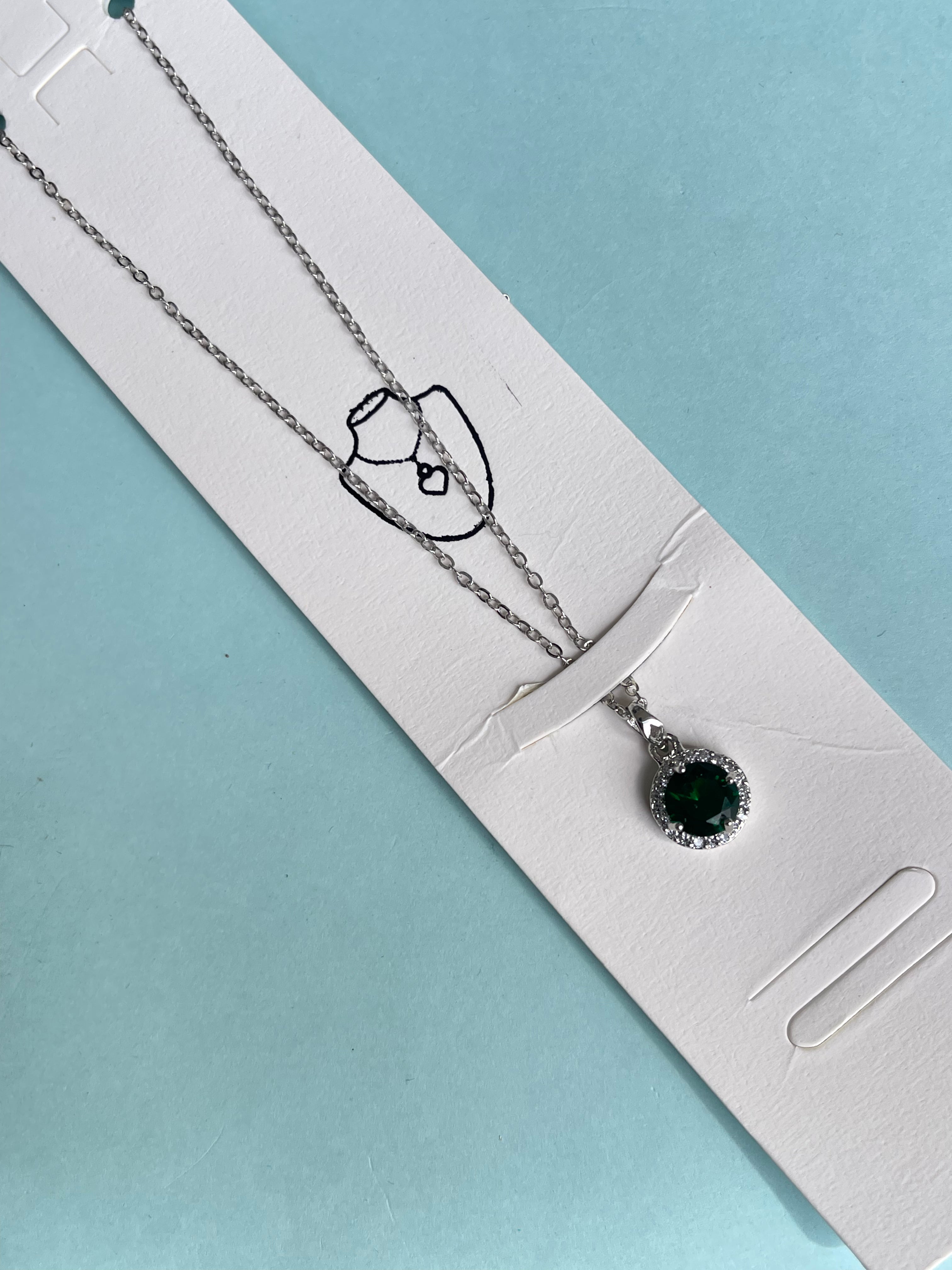 Silver chain with green circle pendant