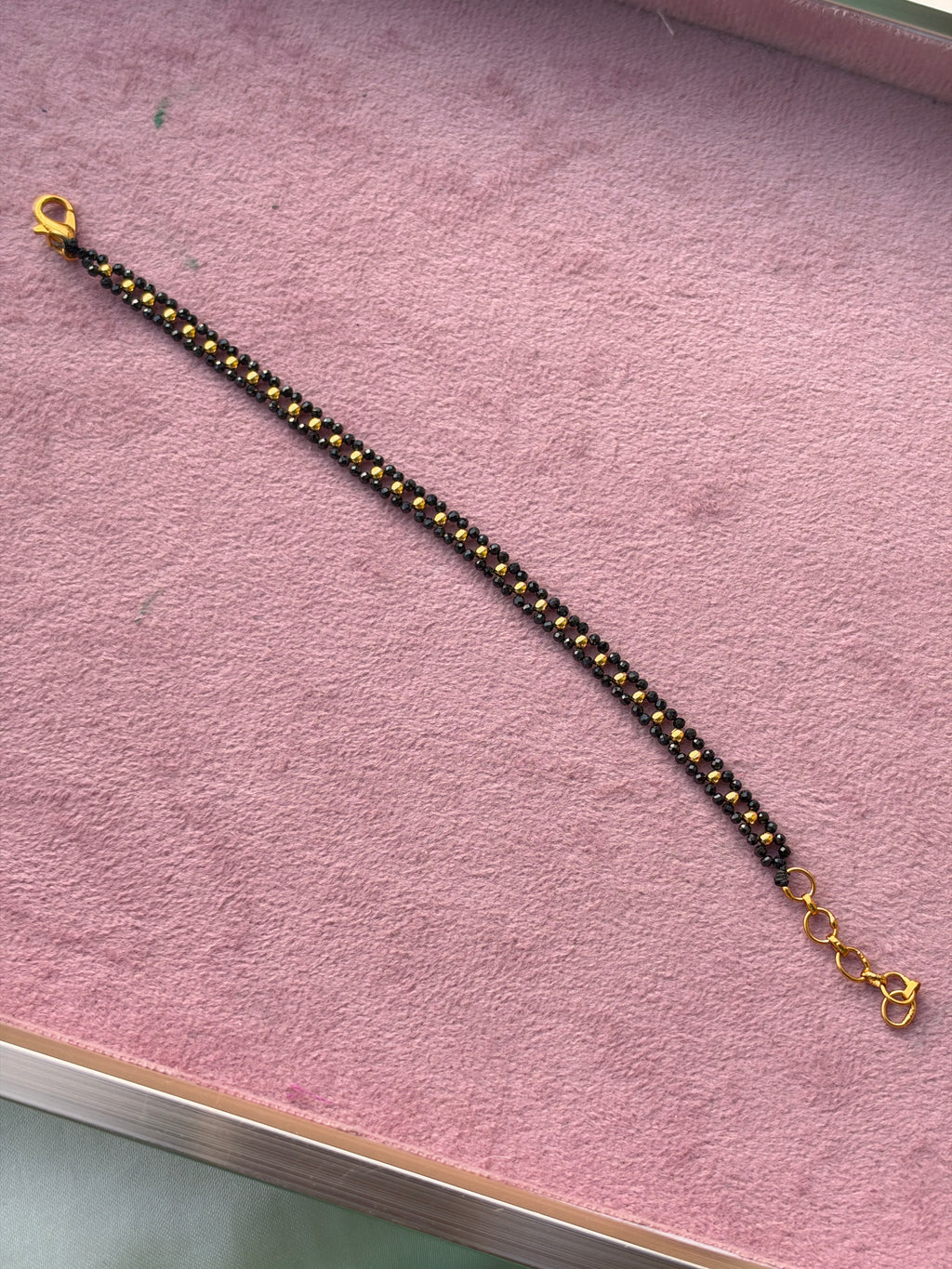 Br009 crystal black bead and gold balls bracelet 6 inches