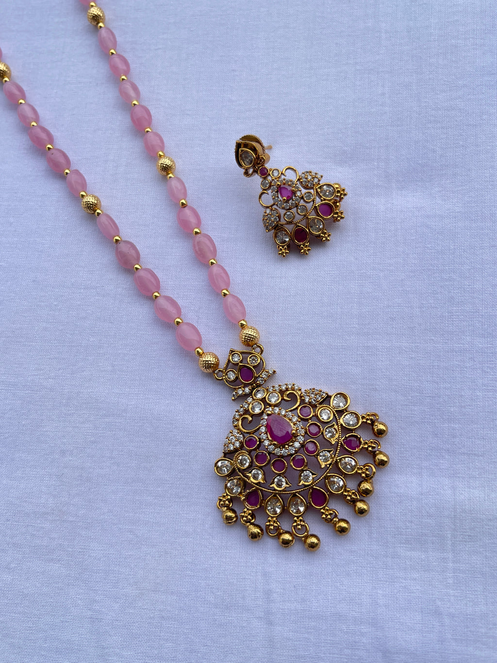 Light pink beads with pendant and earrings
