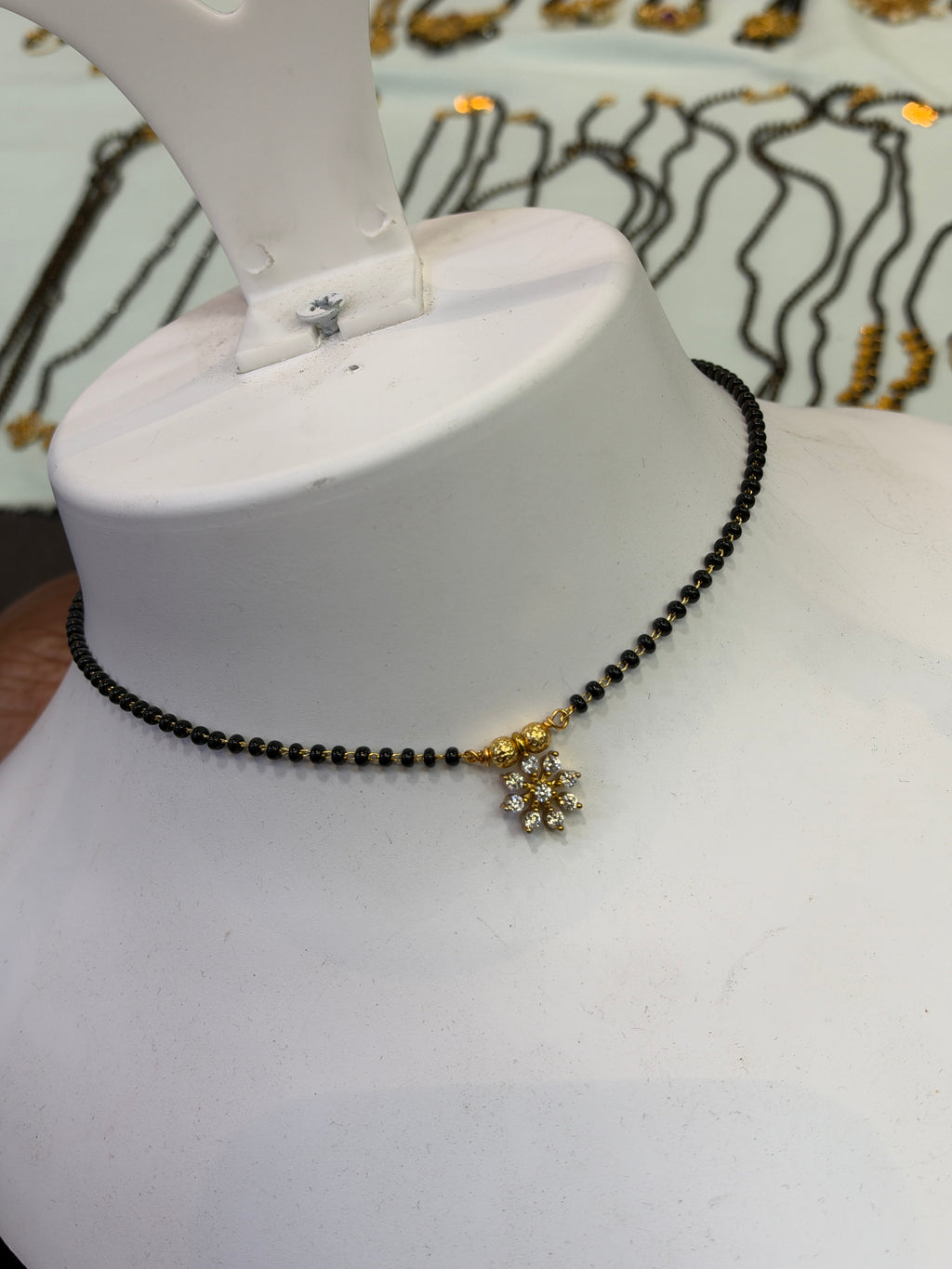 9 stones flower 
Black beads 18 inches BB411