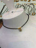 9 stones flower 
Black beads 18 inches BB411