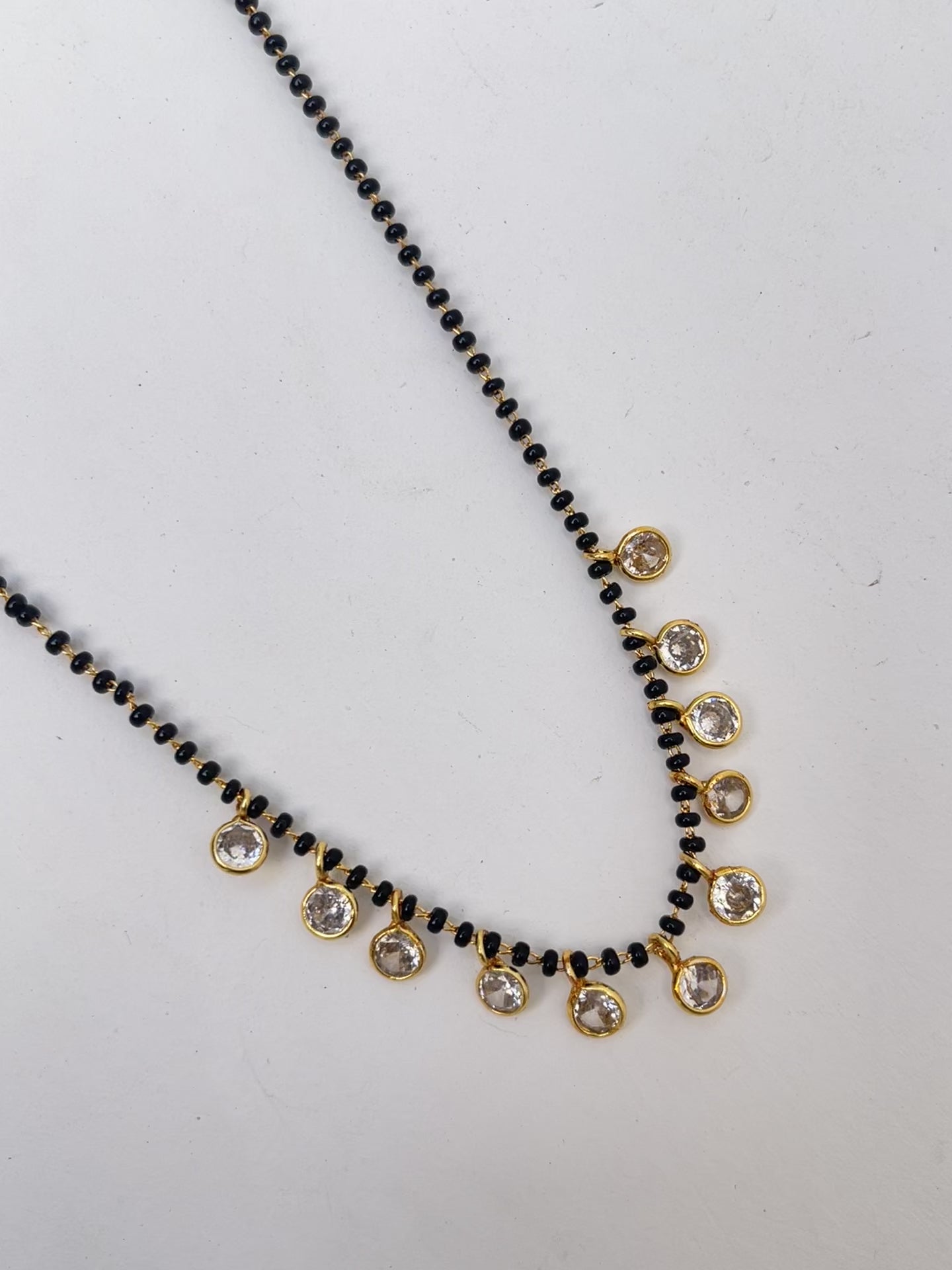 Black beads with 10 white stones